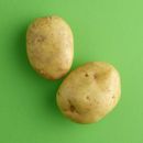 2 Brown Round Fruits on Green Surface