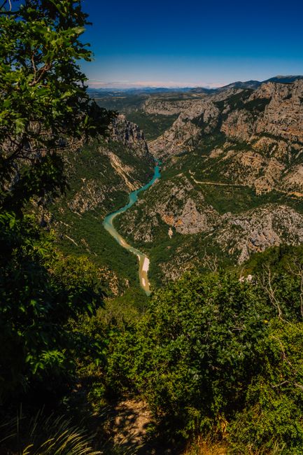 A breathtaking aerial view of the Verdon Gorge with a winding river through rocky mountains in Provence, France.