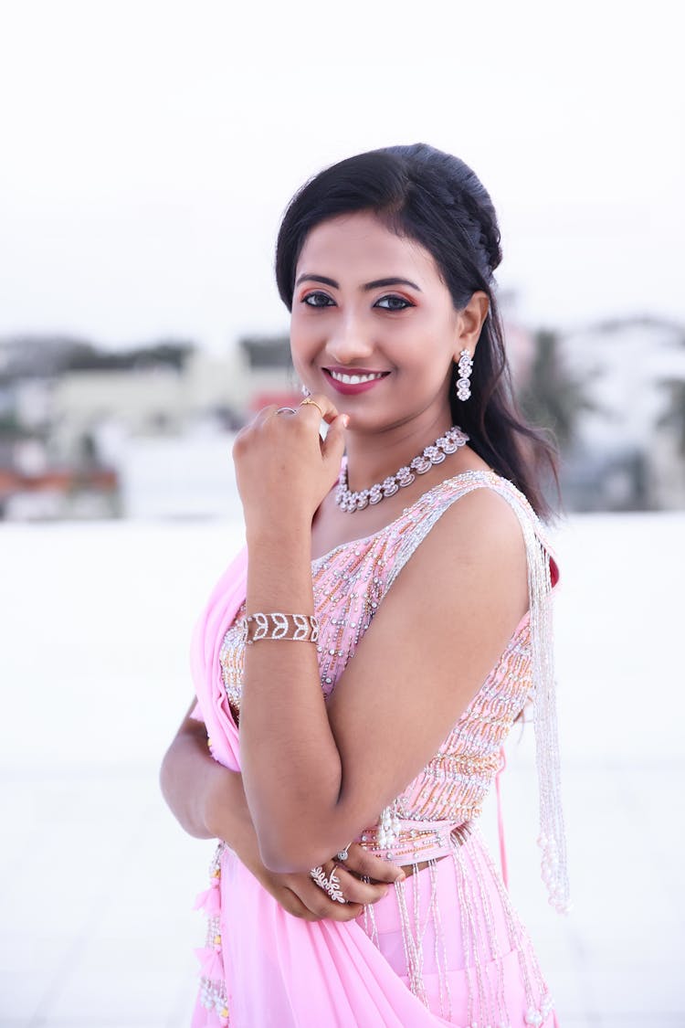 Smiling Woman Wearing A Dress And Jewelry