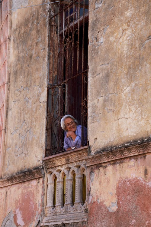 Free Elderly Woman Leaning on Concrete Railing  Stock Photo