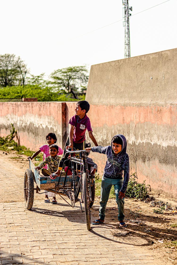 Boys On Bicycle With Trailer