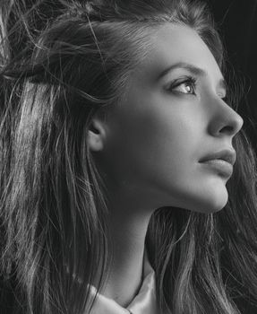 Stunning black and white profile portrait of a woman with a thoughtful expression.