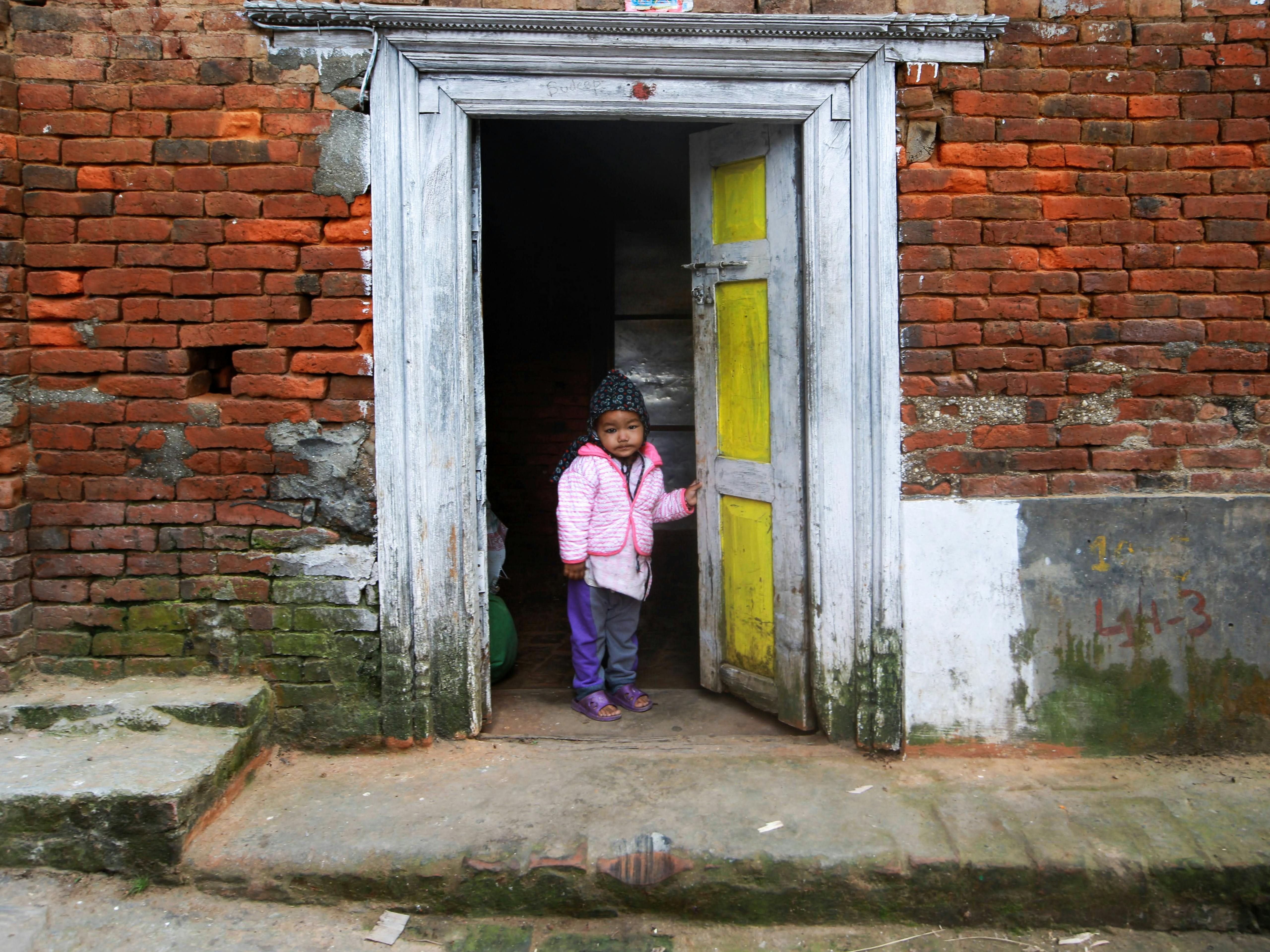 LITTLE GIRL STANDING IN THE DOORWAY TYPICAL NEPALESE BRASS-STUDDED DOOR  NEPAL - Stock Photo - Masterfile - Rights-Managed, Artist: ClassicStock,  Code: 846-03165705