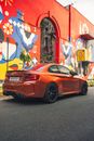 Red Porsche 911 Parked Beside Wall With Graffiti