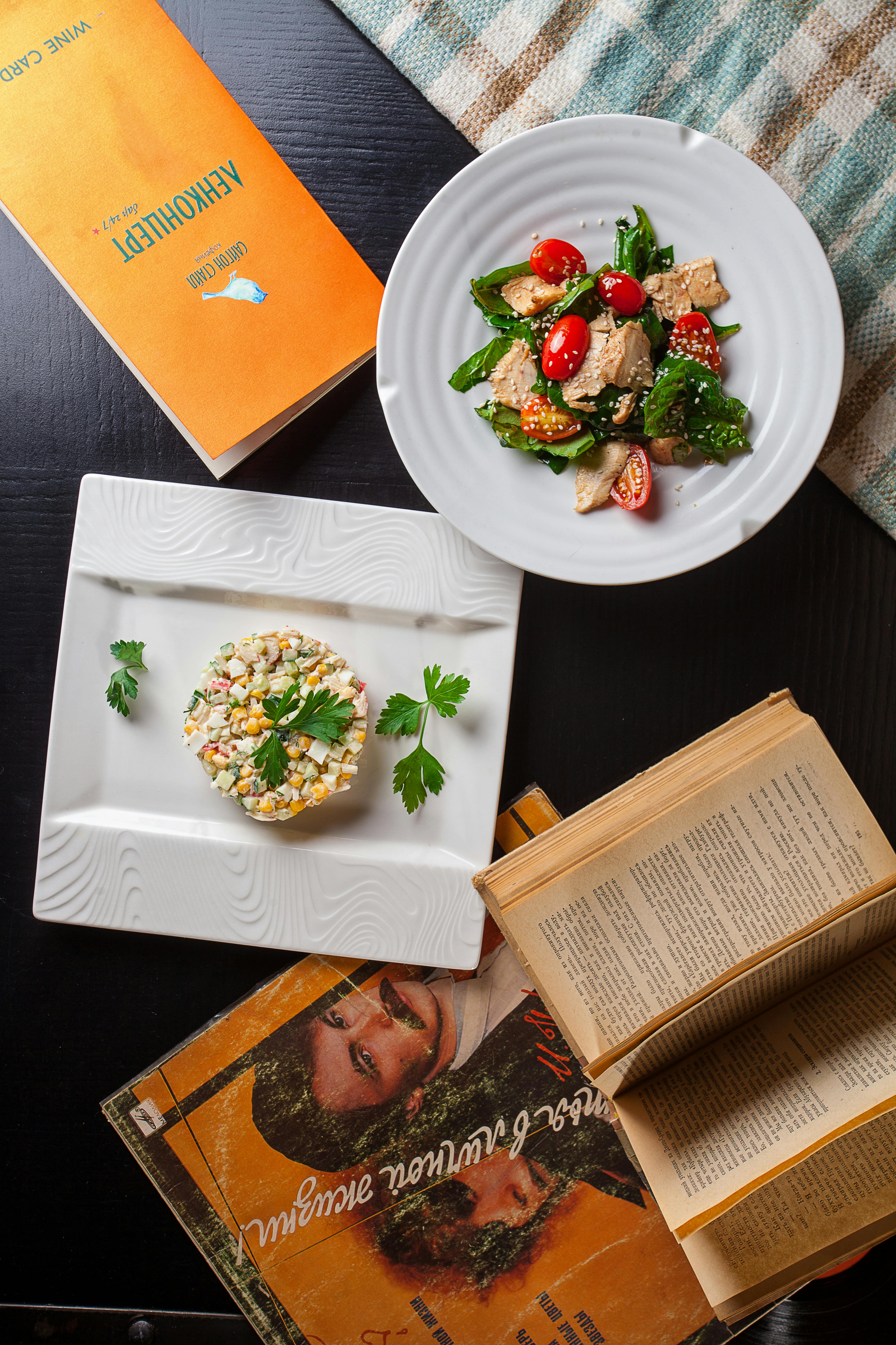 two course meal on white plates and flyers lying on table