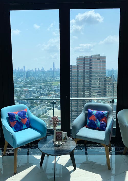 Blue Armchairs Near the Glass Wall 