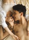 Man and Woman Kissing on Bed