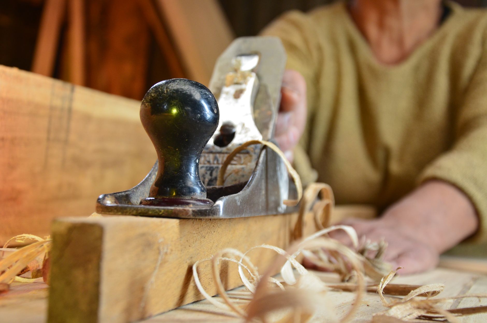 Craftsman shaping oak with a hand plane