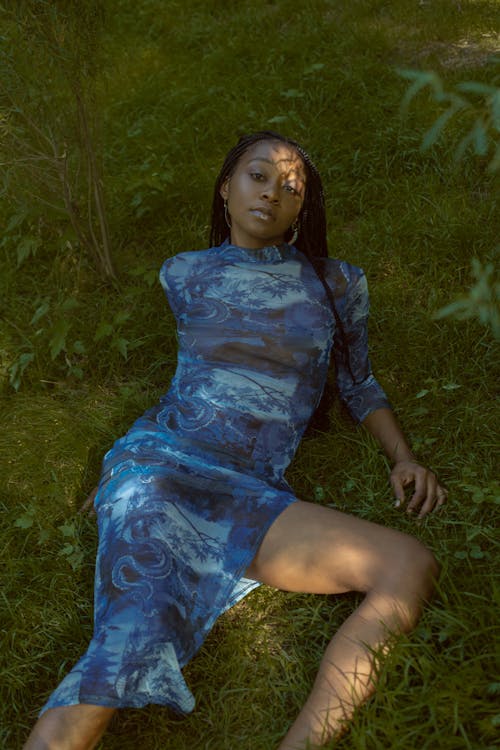 Woman in Blue Dress Lying on Grass