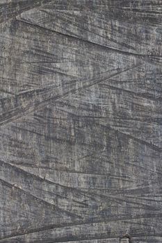Close-up of textured weathered wood surface showing natural patterns and grain details.