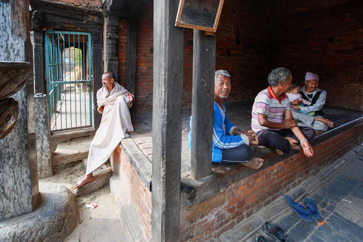 People Sitting Near Closed Door