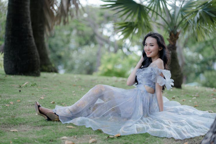 Woman Wearing Gown Sitting On The Ground