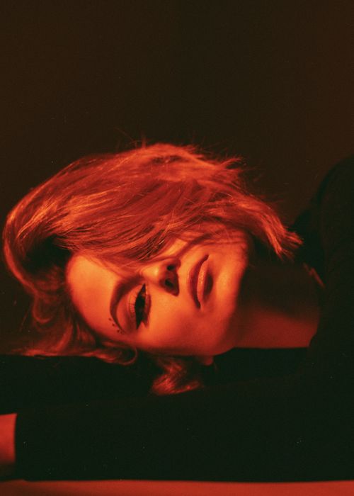 Free Moody portrait of a woman in red lighting, emphasizing beauty and mystery. Stock Photo