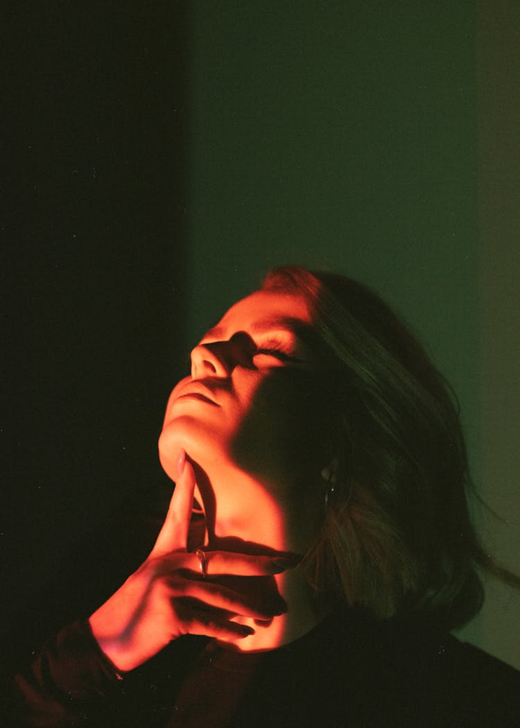 Woman Lifting Her Head With Her Finger