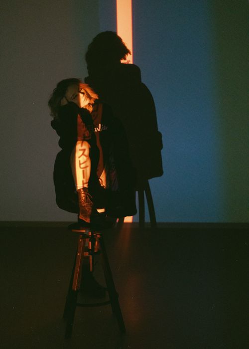 Free Artistic photo of a woman using shadow and light projection in a studio setting. Stock Photo