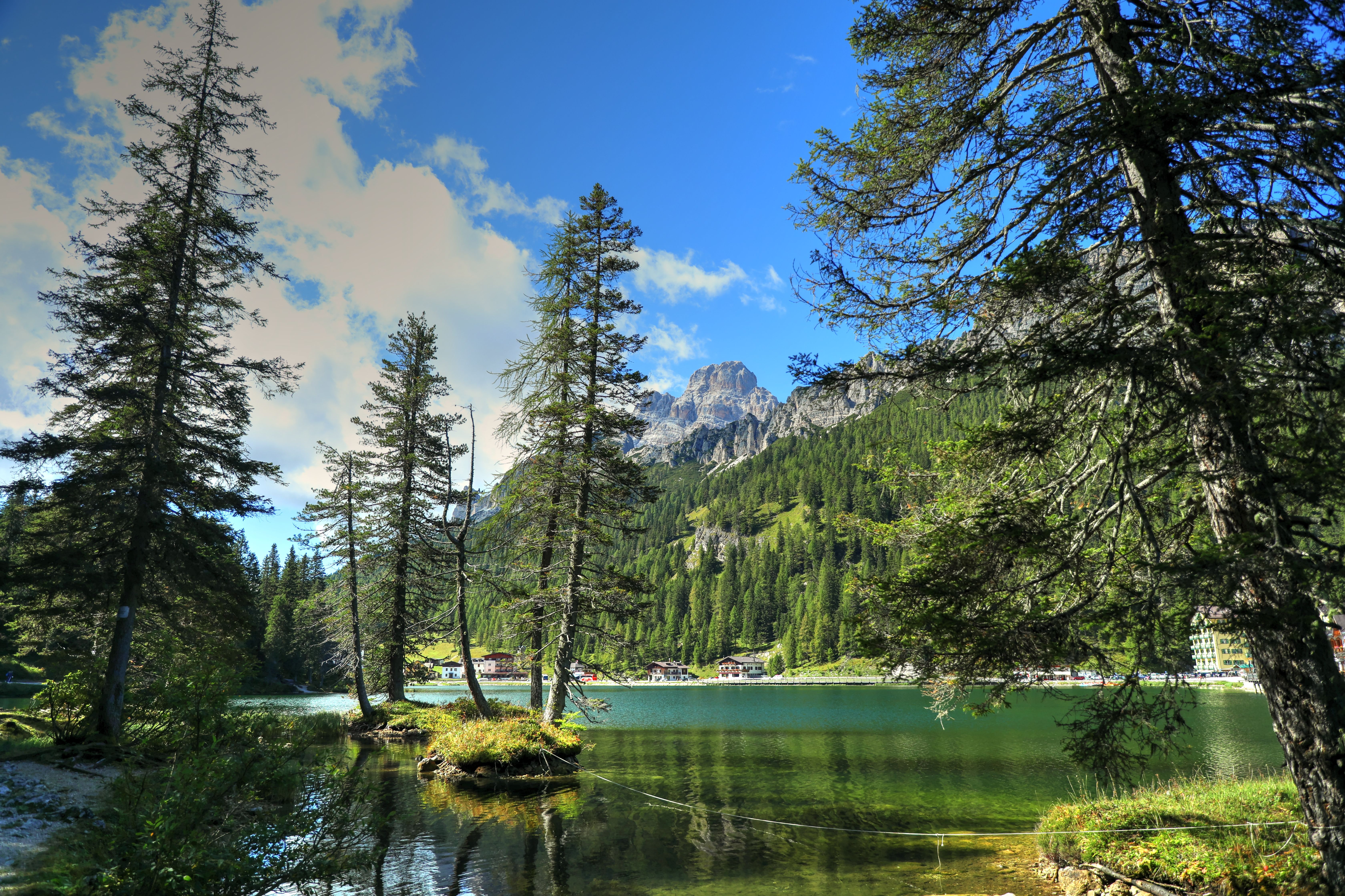 A Lake Between Green Trees on Mountain Under the Blue Sky · Free Stock ...