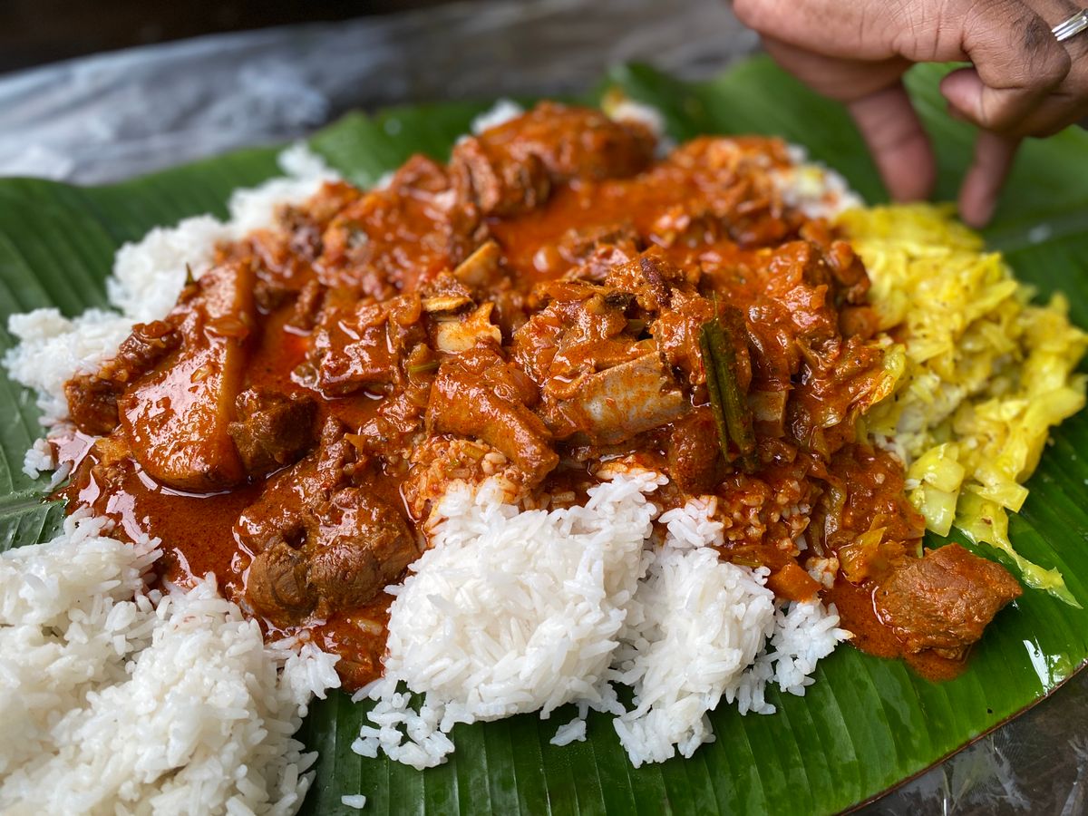 Banana leaf meal with rice and curry served in traditional style