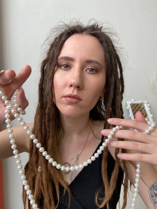 A Woman Holding a Pearl Necklace