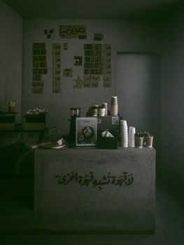 Explore the dark and cozy ambiance of a minimalist coffee shop with stylish decor.