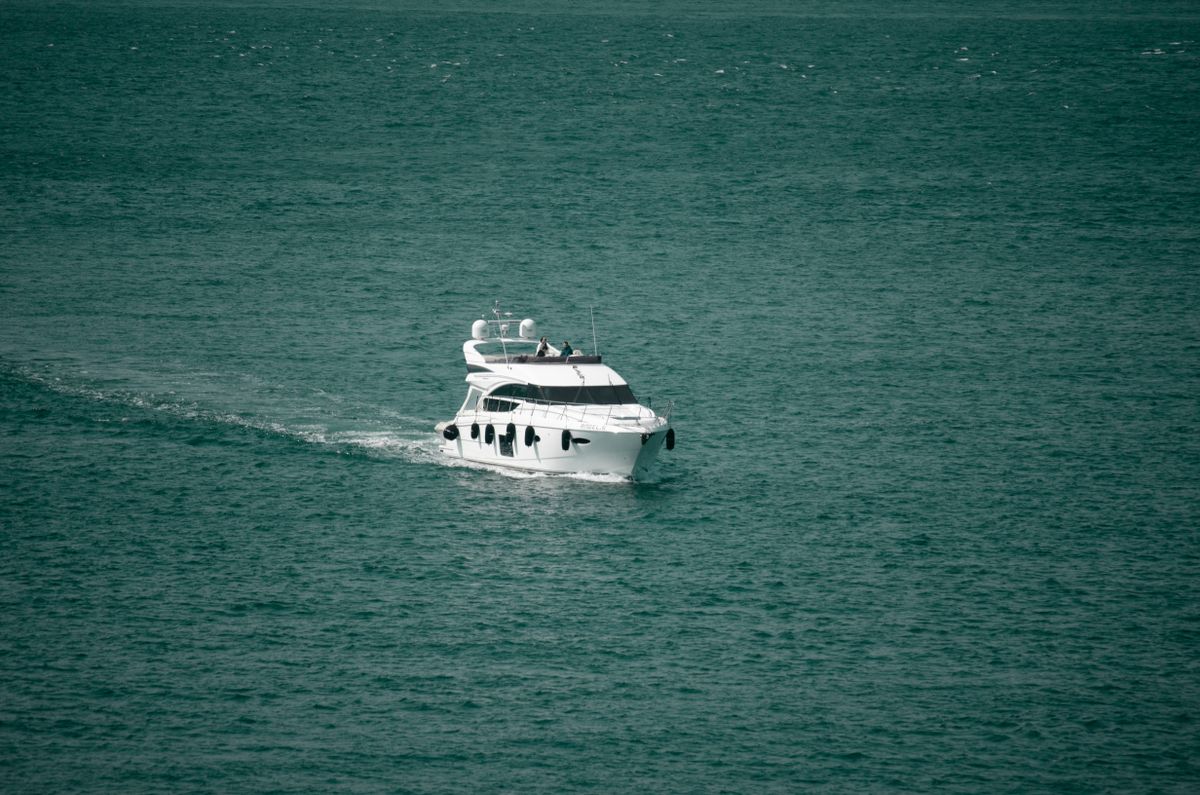 White motor yacht cruising on the open sea