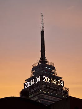 Stunning sunset view of Torre Latinoamericana in Mexico City with illuminated clock.