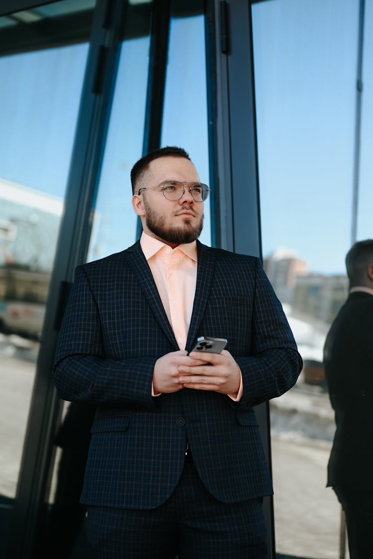 Businessman Walking With Phone In Hands