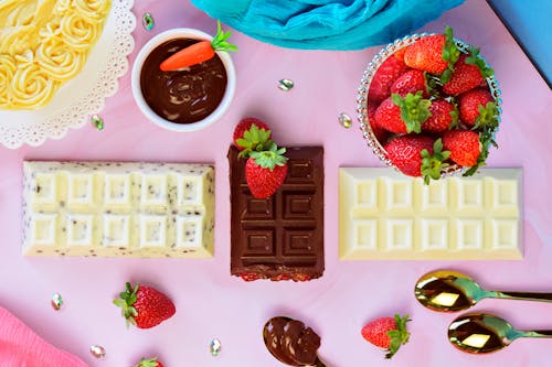 Free Assorted Chocolate Bars and Strawberries Stock Photo