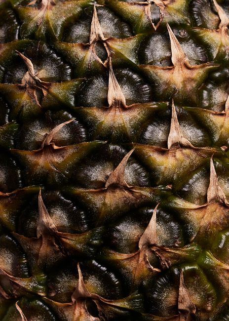 Detailed close-up of pineapple skin texture showcasing its unique pattern and structure.