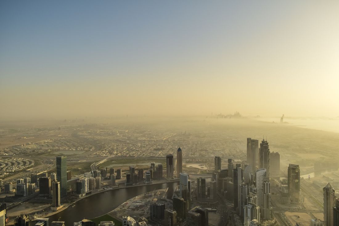 Aerial view of a modern city skyline at sunrise