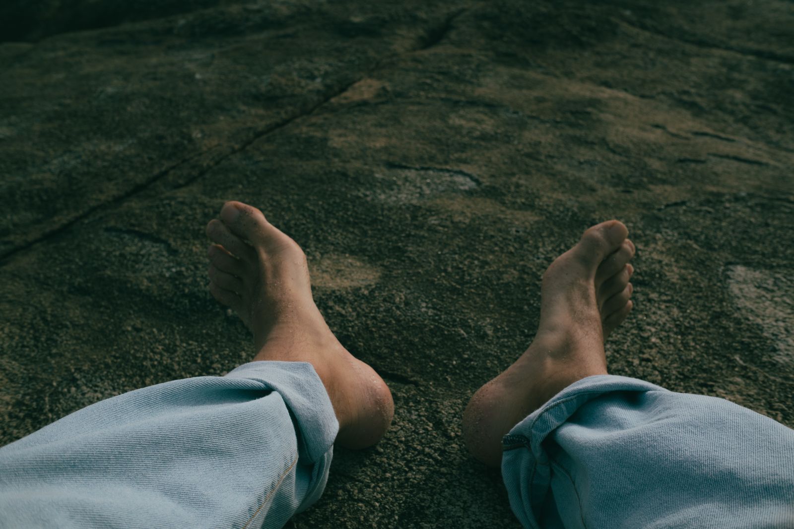 Hiker walking on a bright trail with ankle support considerations for uneven ground