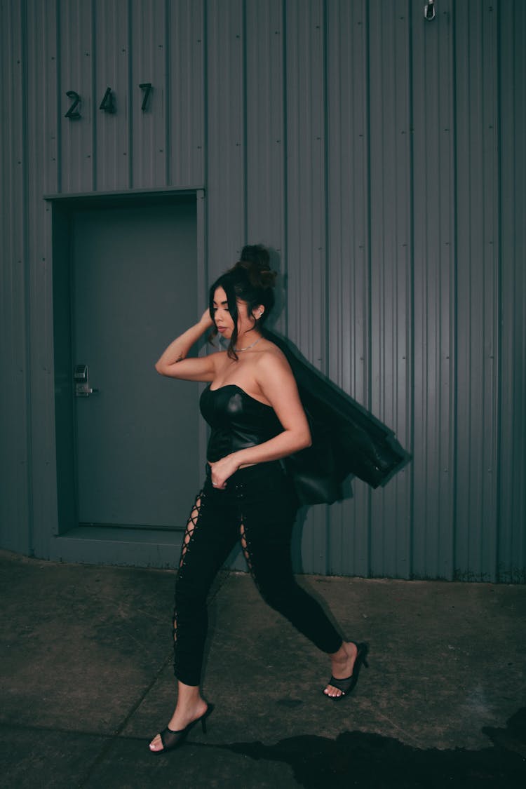 Walking Woman In Black Costume And High-Heels