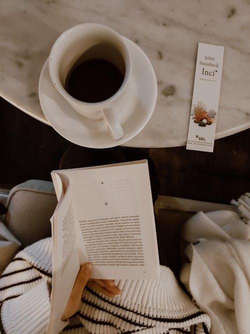 Free Reading Book with Cup of Coffee on Table Stock Photo