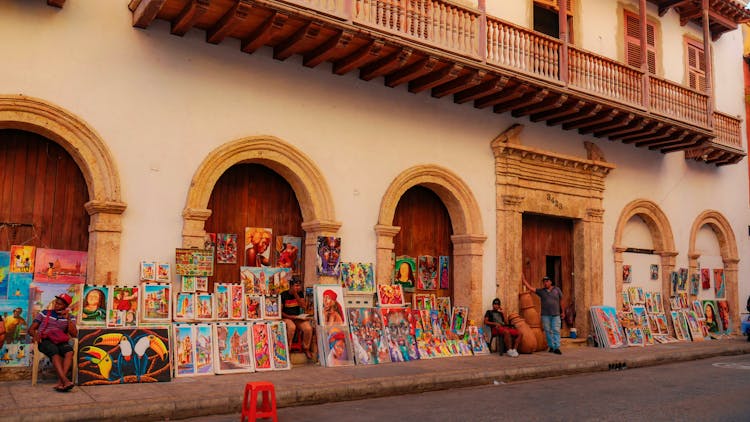 People Selling Paintings On Sidewalk