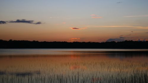 Free A tranquil view of Lake Coba at sunset with reflections on the water. Stock Photo