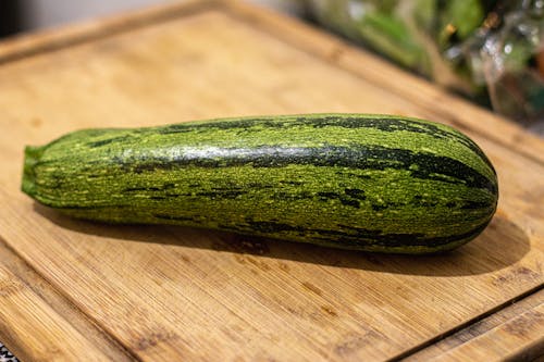 A Zucchini on a Cutting Board 