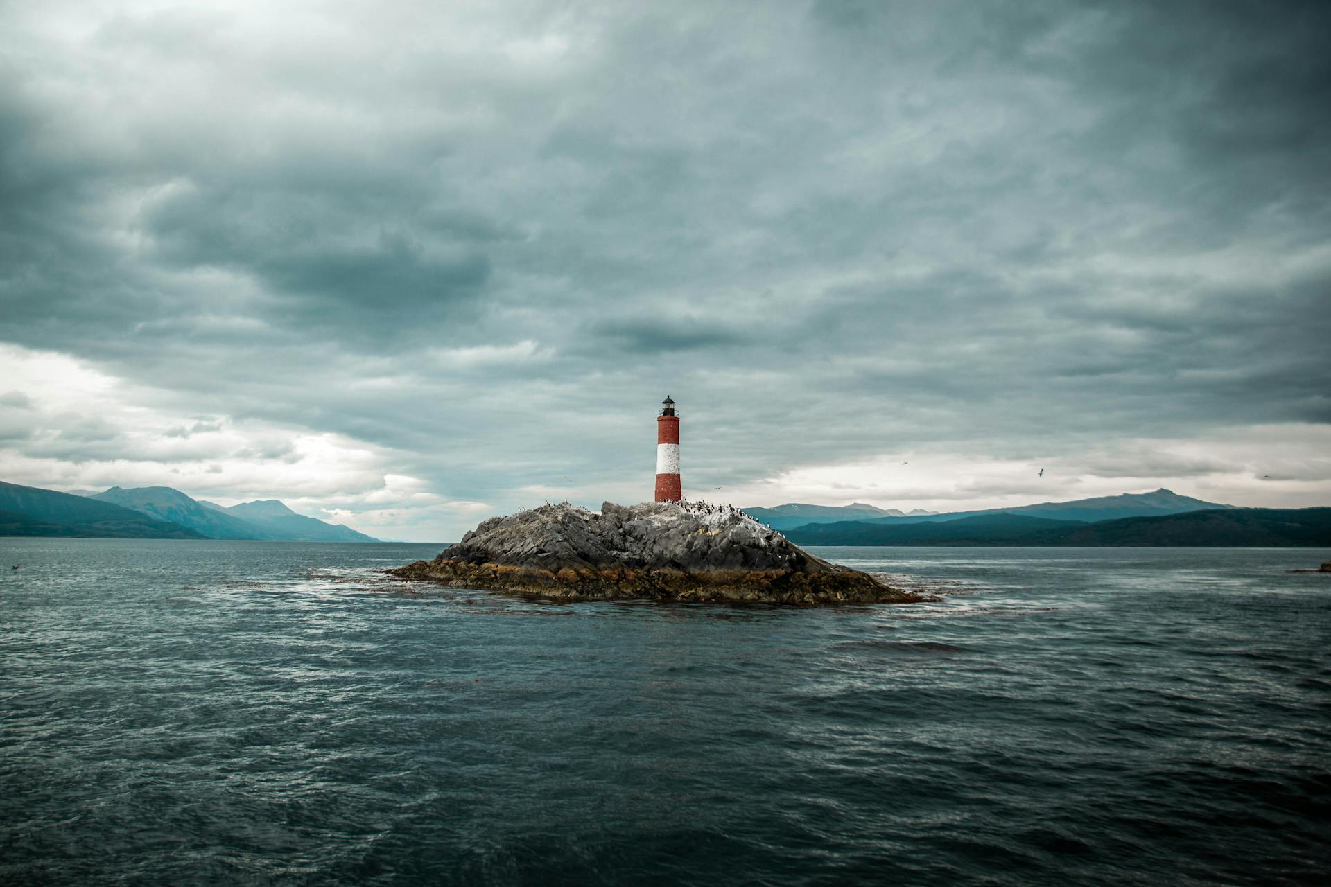 Lighthouse in an Island under Cloudy Sky