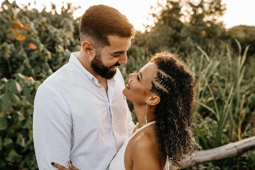 Smiling Man and Woman Standing Face to Face