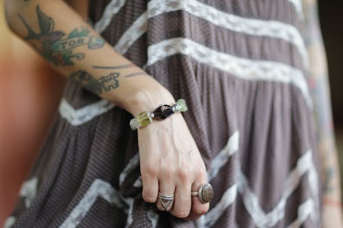 Person Wearing a Bracelet and Rings