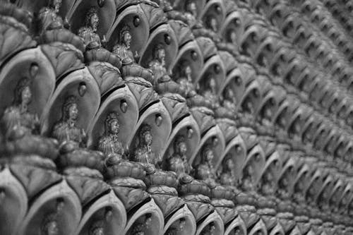 Close-up Photo of Deity Statuette in Monochrome Photography