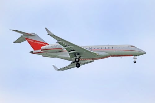 White and Red Airplane in the Sky