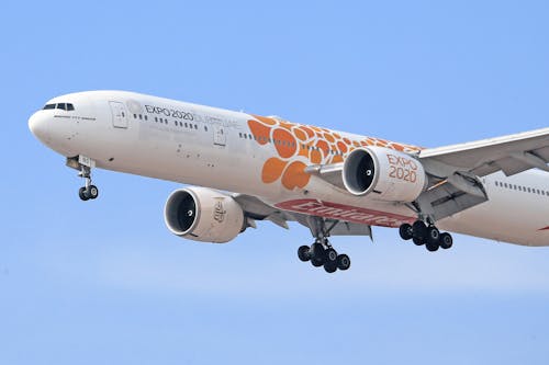 Free White and Orange Airplane Flying Stock Photo