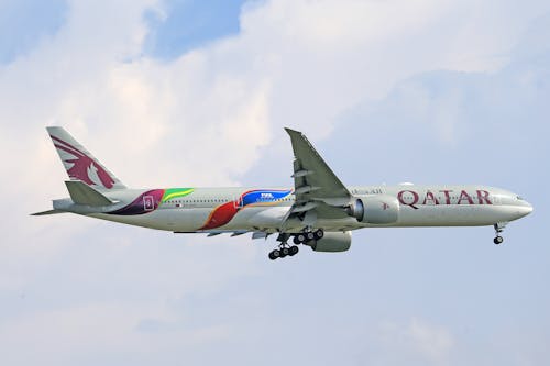 Free Qatar Airways Airplane Flying in the Sky Stock Photo