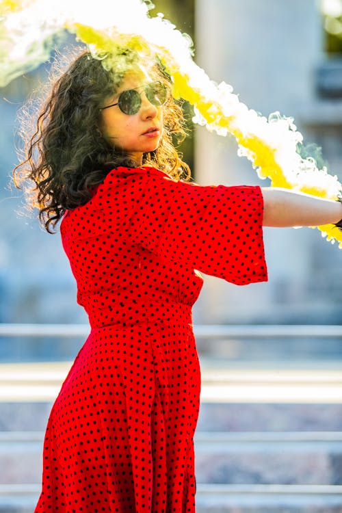 Free A Woman in Sunglasses Holding a Smoke Bomb Stock Photo