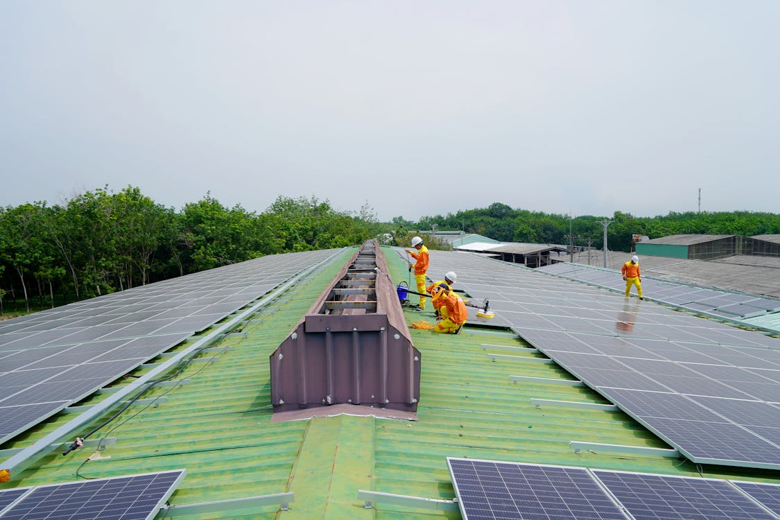 Free Workers Installing Solar on the Roof Stock Photo