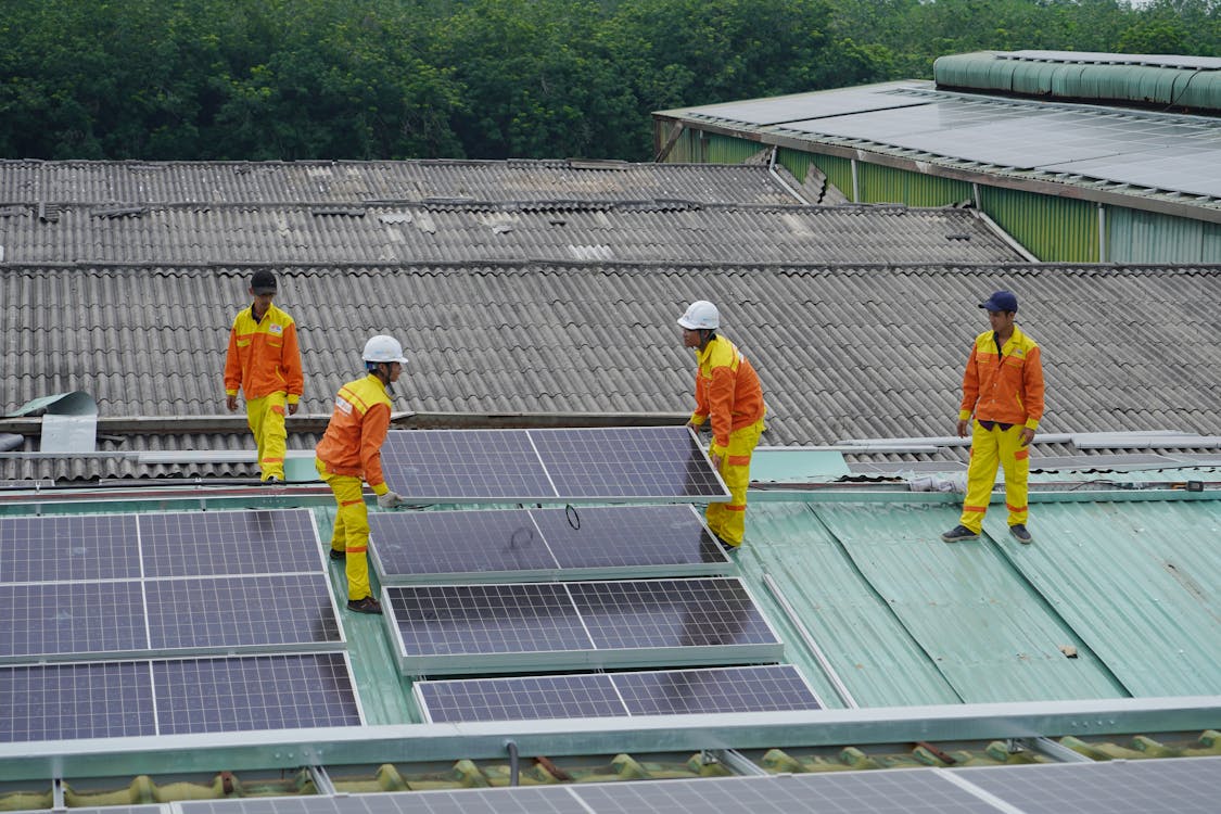 Professionals installing solar panels