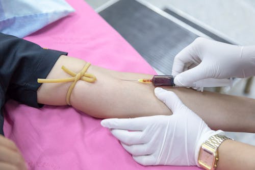 Free Injecting of Syringe on Person's Arm Stock Photo