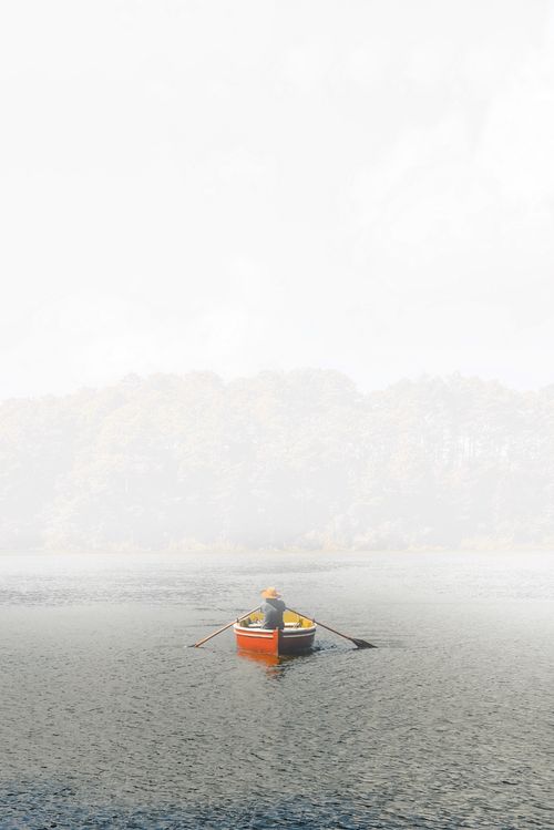 Free A lone person rowing a boat on a misty river, surrounded by nature in Comitán de Domínguez, Mexico. Stock Photo