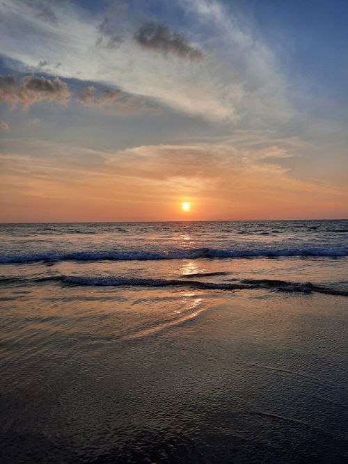 Free Serene seascape at Gokarna Beach with a mesmerizing sunset and tranquil ocean waves. Stock Photo