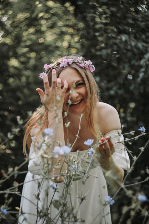 Smiling Woman in White Dress and a Flower Headpiece 