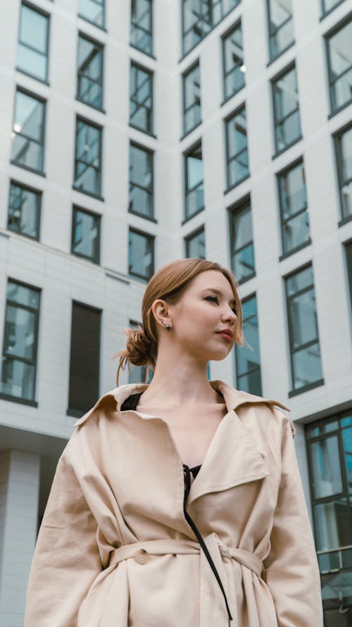 Portrait of Young Woman on the Background of a City Building